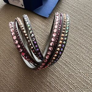 Swarovski -Bracelet 4 rows of colored crystals on grey leather.  Wrap around.